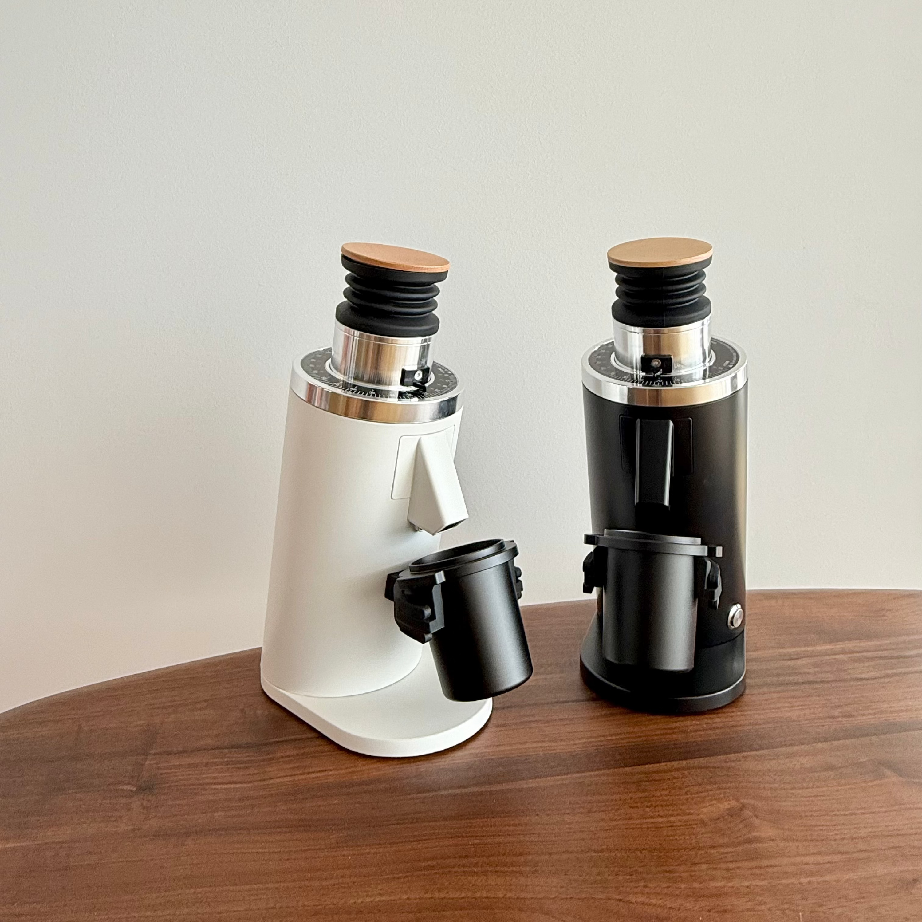 DF54 single-dose coffee grinders in black and white with metal dosing cups - Grind Logic