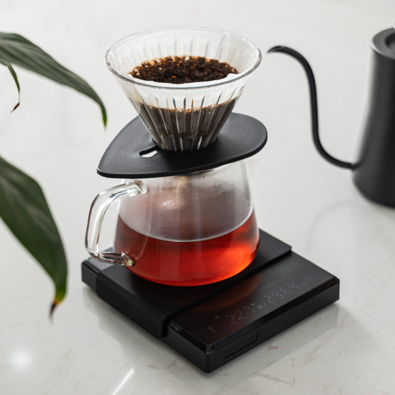 Grind Logic Brew Scale used for pour-over filter coffee with a dripper and glass carafe