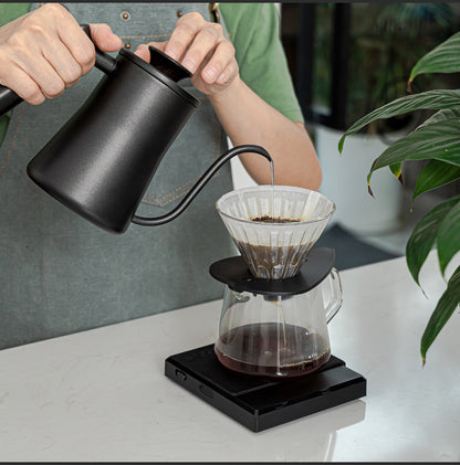 Grind Logic Brew Scale weighing a pour-over coffee brewer during hand brewing