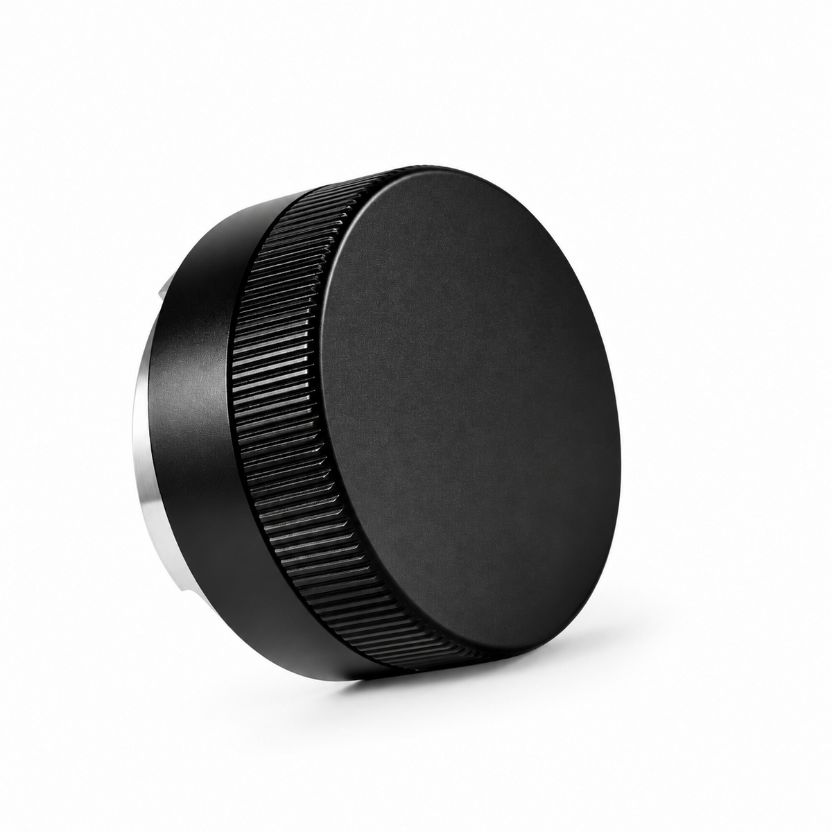 Angled top view of the black Grind Logic coffee distributor, showing its smooth top and textured grip